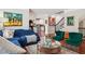Open-concept living room and staircase, with a blue couch and hardwood floors at 2191 Greencroft St, Carmel, IN 46032