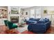 Cozy living room with a fireplace, blue sofa, hardwood floors, and lots of natural light at 2191 Greencroft St, Carmel, IN 46032