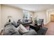 Comfortable living room with neutral tones, two gray sofas, decorative pillows, and a dark coffee table at 2191 Greencroft St, Carmel, IN 46032