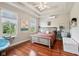 Comfortable main bedroom with a tray ceiling, large windows, and hardwood floors at 2191 Greencroft St, Carmel, IN 46032