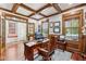 Traditional home office with wood paneling, coffered ceiling, and hardwood floors at 2191 Greencroft St, Carmel, IN 46032