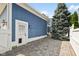 Stone-paved side yard with a door that leads into the home and lush greenery for privacy at 2191 Greencroft St, Carmel, IN 46032