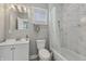 Updated bathroom featuring marble style wall tile, a new vanity, and updated fixtures at 2229 N Arsenal Ave, Indianapolis, IN 46218