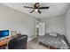 Bright bedroom boasts wood floors, neutral paint, and a dedicated workspace with ample lighting; ready for your personal touch at 2229 N Arsenal Ave, Indianapolis, IN 46218