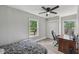 A cozy bedroom is illuminated by natural light, featuring a ceiling fan and comfortable furnishings for restful nights at 2229 N Arsenal Ave, Indianapolis, IN 46218