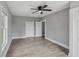 A bright bedroom boasts wood floors, white trim, a ceiling fan, and two closets providing ample storage space at 2229 N Arsenal Ave, Indianapolis, IN 46218
