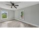 Bright bedroom with wood floors, ceiling fan, and two windows offering plenty of natural light at 2229 N Arsenal Ave, Indianapolis, IN 46218