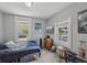 Inviting bedroom with wood-look floors, neutral walls and large windows for natural light at 2229 N Arsenal Ave, Indianapolis, IN 46218