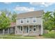Charming two-story home with a covered porch, vinyl siding, and a well-maintained front yard at 2229 N Arsenal Ave, Indianapolis, IN 46218