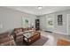 Spacious living room with wood-look floors, area rug and filled with plentiful natural light at 2229 N Arsenal Ave, Indianapolis, IN 46218