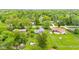 Aerial view of a home with a large, green, fenced-in backyard in a tree-filled neighborhood with blue skies at 2309 Alexandria Dr, Greenfield, IN 46140