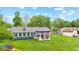 Aerial perspective of a backyard showcasing a patio with outdoor furniture, a grill, and a well-maintained lawn at 2309 Alexandria Dr, Greenfield, IN 46140