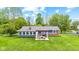 Aerial view of a spacious backyard with a patio, grill, and seating, ideal for entertaining and relaxation at 2309 Alexandria Dr, Greenfield, IN 46140