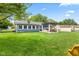 A large backyard features a well-maintained lawn and a charming pergola-covered patio area at 2309 Alexandria Dr, Greenfield, IN 46140