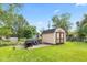 A backyard shed with a concrete foundation offers storage for gardening and yard equipment at 2309 Alexandria Dr, Greenfield, IN 46140