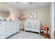 A cozy Bedroom features a crib, dresser, rocking chair, and decorative accents at 2309 Alexandria Dr, Greenfield, IN 46140