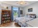 Cozy bedroom featuring a comfortable bed, wood-look floors, natural light, and a decorative bookcase at 2309 Alexandria Dr, Greenfield, IN 46140