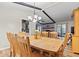 Spacious dining room features a traditional wooden table, eight chairs, and an elegant chandelier under a beamed ceiling at 2309 Alexandria Dr, Greenfield, IN 46140
