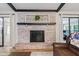 Living room showcasing a brick fireplace with a wooden mantle and an eye-catching decorative wreath at 2309 Alexandria Dr, Greenfield, IN 46140