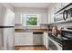 Charming kitchen featuring stainless steel appliances, white cabinets, and stylish backsplash for a modern touch at 2309 Alexandria Dr, Greenfield, IN 46140