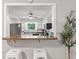 The kitchen features white cabinets and a stainless steel refrigerator, viewed through a pass-through at 2309 Alexandria Dr, Greenfield, IN 46140