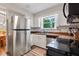 Bright kitchen with stainless steel appliances, white cabinetry, a window view, and wood countertops at 2309 Alexandria Dr, Greenfield, IN 46140