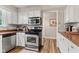 Well-lit kitchen featuring stainless steel appliances, white cabinets, and stylish backsplash and durable countertops at 2309 Alexandria Dr, Greenfield, IN 46140