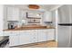 View from the kitchen with light cabinetry, wood countertops, stainless steel refrigerator, and views into the living room at 2309 Alexandria Dr, Greenfield, IN 46140