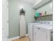 Functional laundry room equipped with a washer, dryer, and shelving for storage and organization at 2309 Alexandria Dr, Greenfield, IN 46140