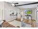 Open-concept living area with hardwood flooring, white walls, and a pass-through window into the kitchen at 2309 Alexandria Dr, Greenfield, IN 46140