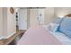 Bedroom features wood floors, warm lighting, and sliding barn doors to bathroom and closet at 2309 Alexandria Dr, Greenfield, IN 46140