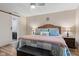 Serene main bedroom with wood floors, a sliding barn door to en suite, and warm lighting at 2309 Alexandria Dr, Greenfield, IN 46140
