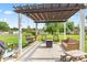 Spacious outdoor patio with a pergola, swing, seating, and a great backyard view at 2309 Alexandria Dr, Greenfield, IN 46140