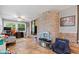 Bright sunroom with brick accent wall, tile flooring, multiple windows, and space for recreation and relaxation at 2309 Alexandria Dr, Greenfield, IN 46140