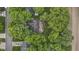 An aerial view of a home nestled among lush trees, highlighting its backyard and outdoor spaces at 2397 Lincoln Dr, Cicero, IN 46034