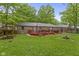 The spacious back yard includes a deck, play equipment, and a lush lawn for outdoor activities at 2397 Lincoln Dr, Cicero, IN 46034