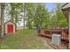 Lush backyard with a red storage shed, deck, and plenty of green space for outdoor activities at 2397 Lincoln Dr, Cicero, IN 46034