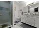 Bathroom featuring a glass-enclosed shower and a vanity with a marble countertop and ample storage at 2397 Lincoln Dr, Cicero, IN 46034