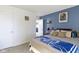 Bedroom featuring a bed with a blue-patterned blanket, a nightstand, and neutral carpet at 2397 Lincoln Dr, Cicero, IN 46034