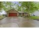 Charming brick ranch home with a red garage door and mature trees surrounding the property at 2397 Lincoln Dr, Cicero, IN 46034