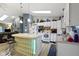 Sunlit kitchen features white cabinets, a breakfast bar with unique glass block, and modern appliances at 2397 Lincoln Dr, Cicero, IN 46034