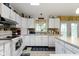 Well-lit kitchen with white cabinets, laminate countertops, and a window over the sink at 2397 Lincoln Dr, Cicero, IN 46034