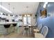 Spacious kitchen/dining combo with unique lighting, breakfast bar, table with 6 chairs, and white cabinetry at 2397 Lincoln Dr, Cicero, IN 46034
