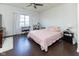 Bright bedroom with dark hardwood flooring and a large window, creating a serene and inviting atmosphere at 2717 Arklow Way, Brownsburg, IN 46112