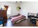 Cozy bedroom featuring wood flooring, window for natural light and personal decor at 2717 Arklow Way, Brownsburg, IN 46112