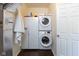 A functional laundry room featuring stacked washer and dryer units, plus extra storage space at 2717 Arklow Way, Brownsburg, IN 46112