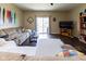 A cozy living room showcasing a comfortable sofa, ample natural light, and a seamless flow to the backyard at 2717 Arklow Way, Brownsburg, IN 46112