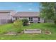Lush backyard with well-maintained lawn, garden beds, and home exterior at 2911 W Hawanian Ln, Monrovia, IN 46157