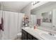 Bathroom with a double sink vanity, white shower curtain, and contemporary fixtures offers functionality and style at 2911 W Hawanian Ln, Monrovia, IN 46157