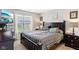 Comfortable bedroom with a large window and modern decor, featuring patterned bedding and a serene atmosphere at 2911 W Hawanian Ln, Monrovia, IN 46157
